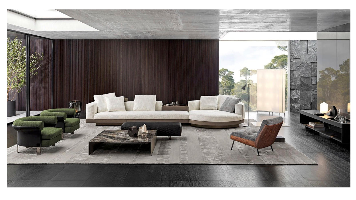 Modern living room with a sectional sofa, armchairs, and coffee table.