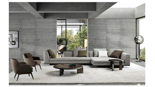 Modern living room with gray sofa, armchairs, and coffee table in a stylish interior.