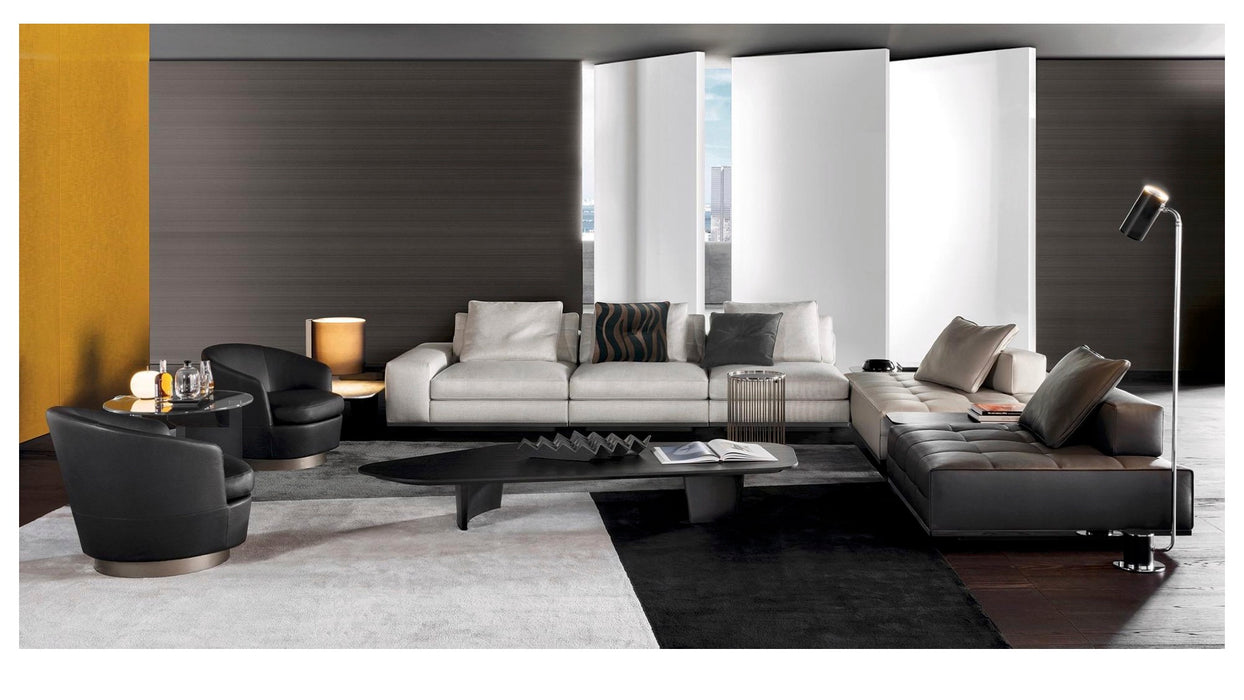 Modern living room with a sectional sofa, coffee table, and decorative items.