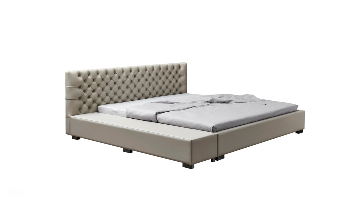 Beige upholstered bed with tufted headboard