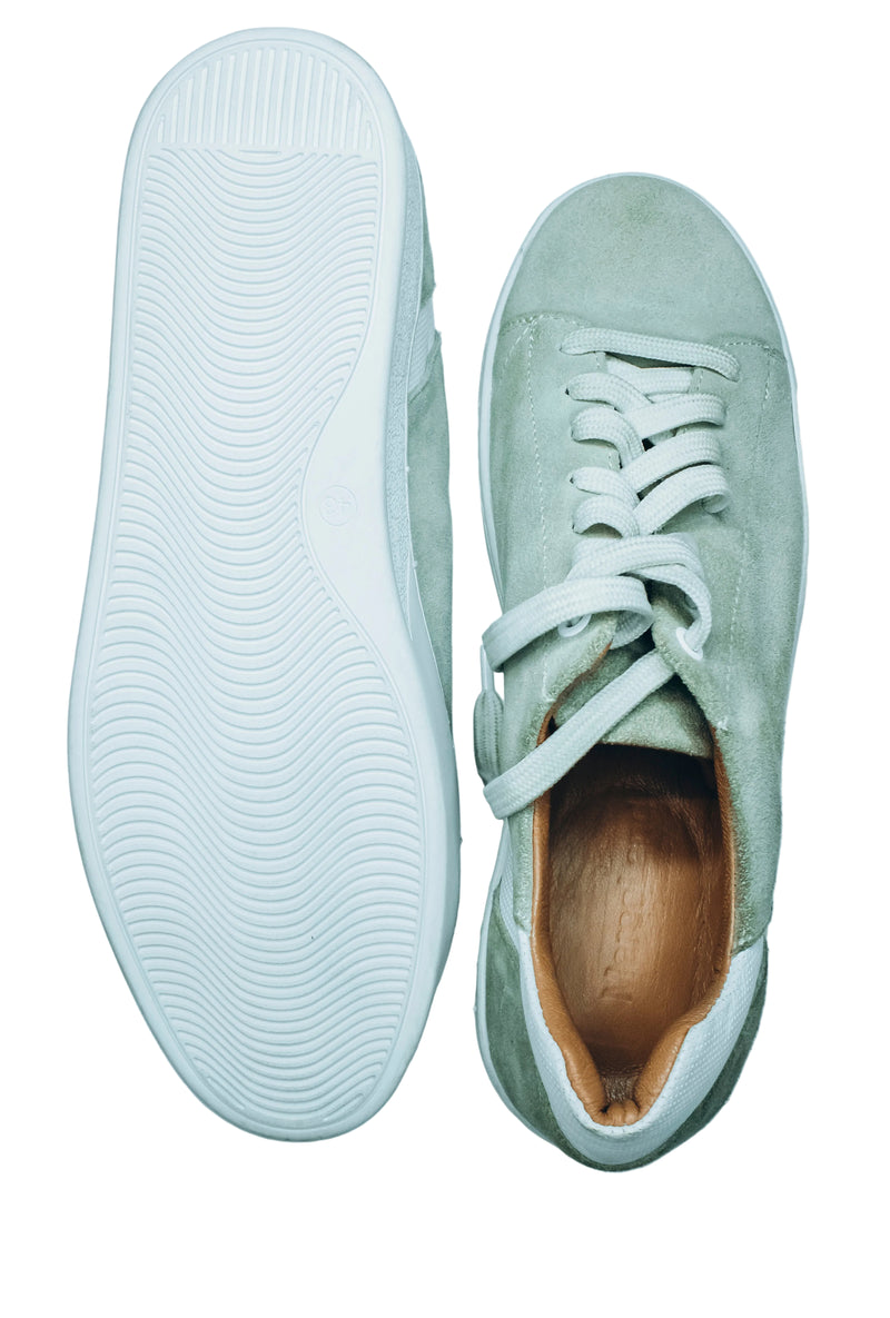Suede low-top sneakers in a light green, mint, or sage color with white laces and white rubber soles|Casual low-top sneaker.
