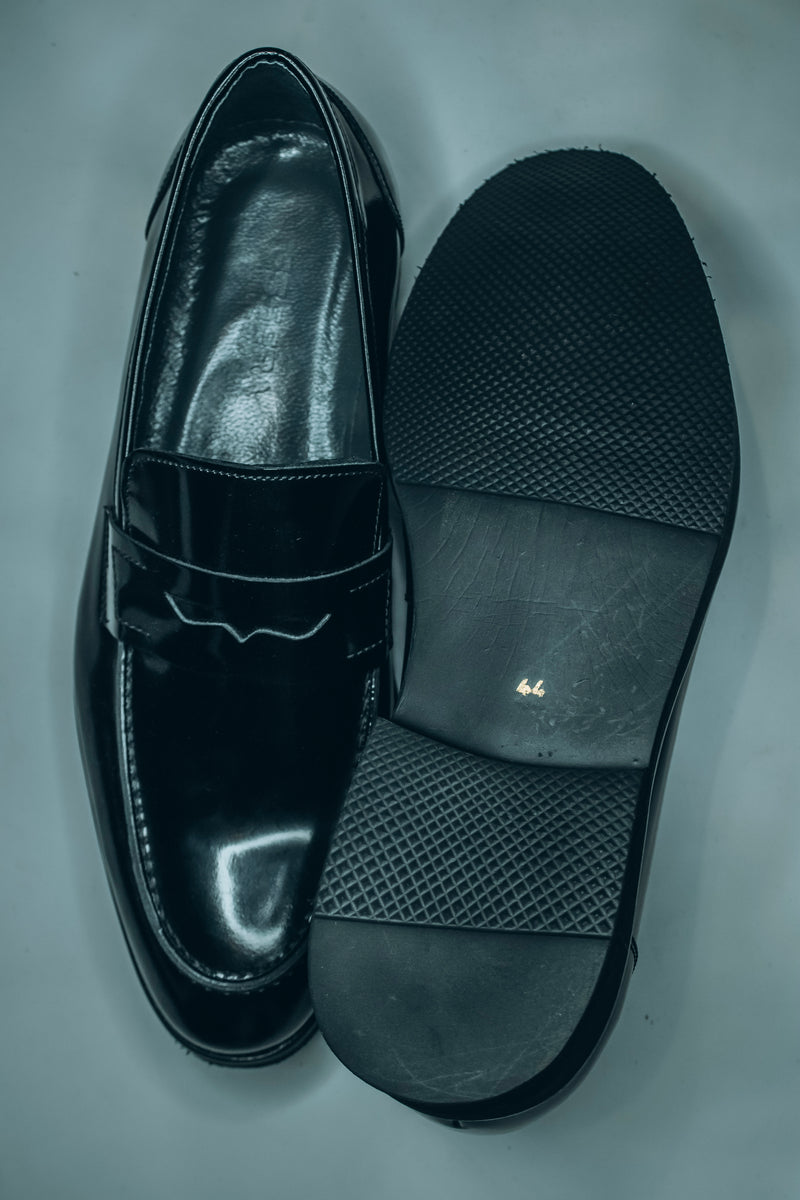 Salvatore Ferragamo black patent leather penny loafers|a classic style of formal and semi-formal footwear.