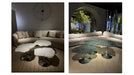 Two views of a modern living room with a sectional sofa and glass coffee table.