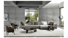Modern living room with gray sofa, armchairs, and coffee table in a stylish interior.