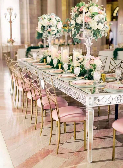 Elegant dining table set with floral centerpieces in a formal setting