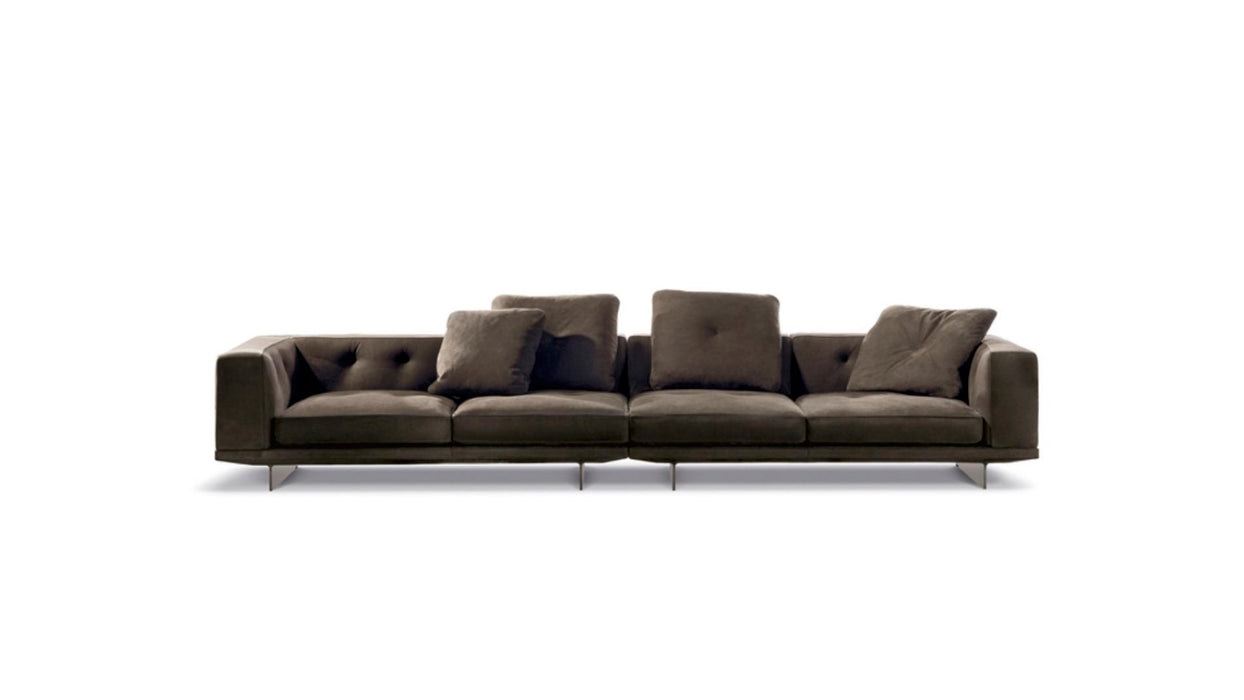 Dark gray sofa with tufted backrests on a white background
