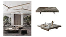 Modern ceiling light fixture and marble table with decorative items in a stylish interior setting.