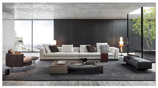 Modern living room with a white sofa, coffee table, and decorative items.