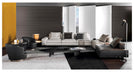 Modern living room with a sectional sofa, coffee table, and decorative items.