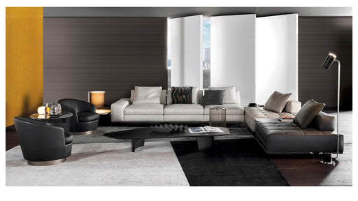 Modern living room with a sectional sofa, coffee table, and decorative items.