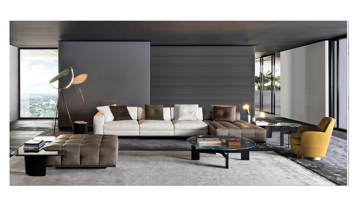 Modern living room with a sectional sofa, armchair, and coffee table.