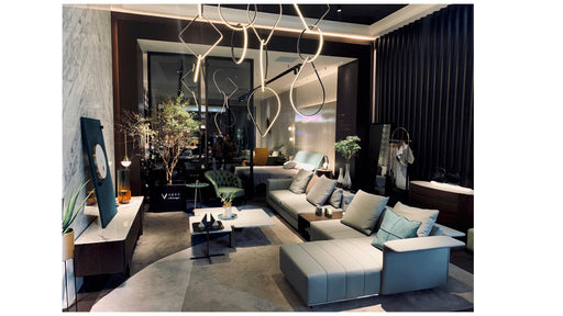 Modern living room with a gray sectional sofa, decorative plants, and stylish decor.