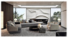 Modern living room with gray sofa, coffee table, and decorative items.