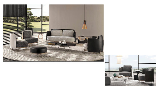 Modern living room furniture set with sofa, chairs, and coffee table in a stylish interior setting.