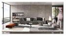 Modern living room with gray sofa, coffee table, and decorative items.
