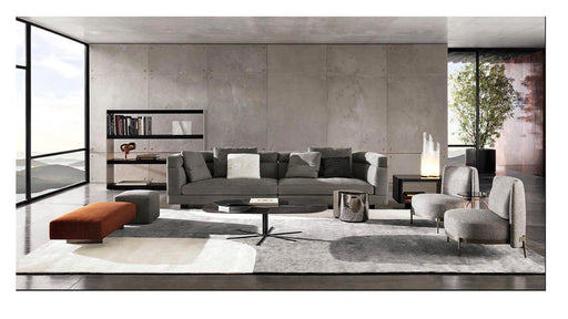 Modern living room with gray sofa, coffee table, and decorative items.